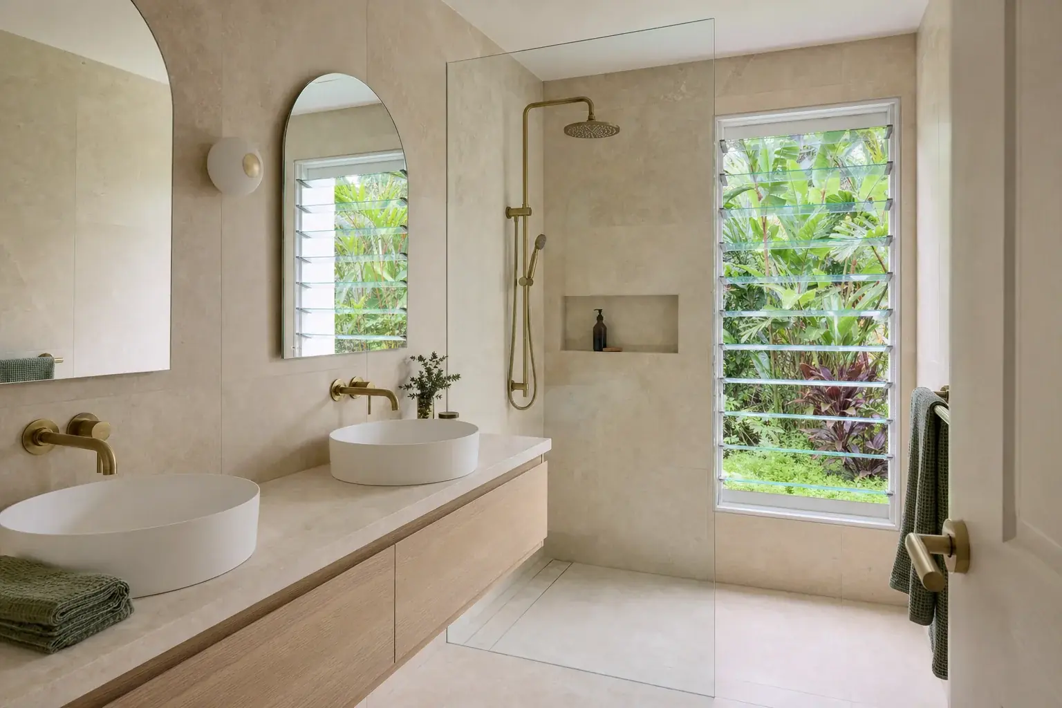 Renovated bathroom in Burleigh Heads with warm neutral tiling, a wall-hung timber vanity with a stone top and a frameless walk-in shower